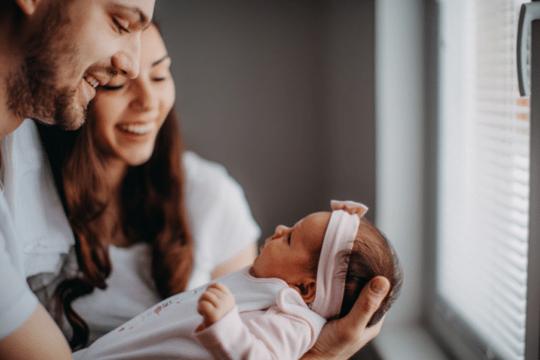 Happy Couple With Little Miracle Baby