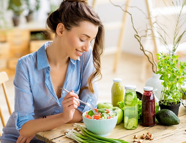 happy-healthy-woman-eating-folic-acid-rich-salad