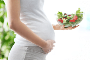 healthy-pregnant-woman-with-white-shirt-eating-healthy-salad